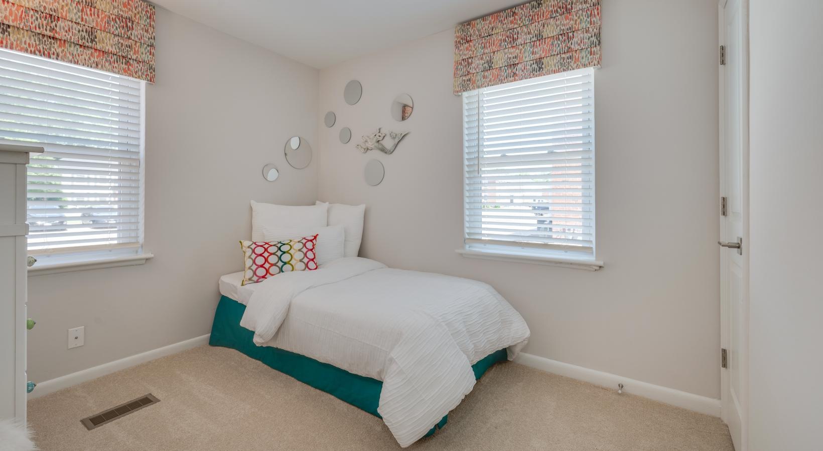 Relax and recharge in beautiful and spacious bedrooms windows brighten carpeted bedroom