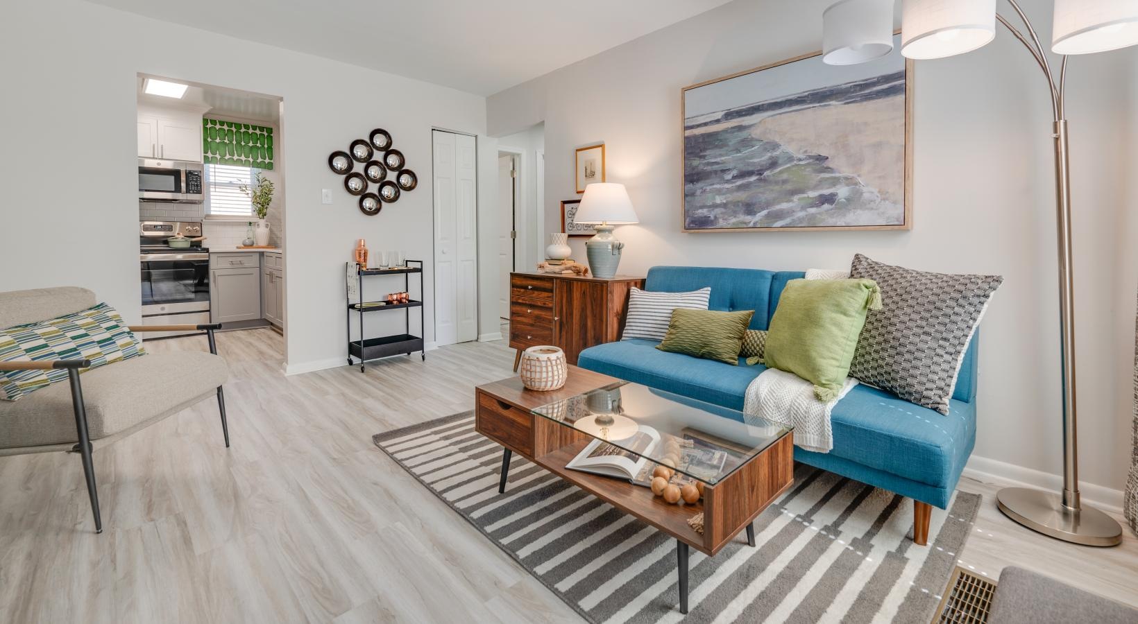 Generous living spaces to relax and unwind furnished living room adjacent to kitchen